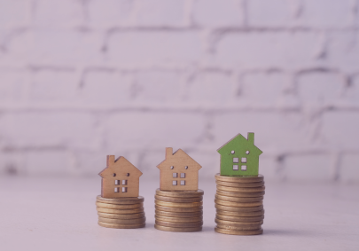Image of wooden model houses with on pound coins