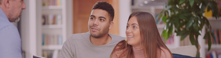 Young couple reviewing mortgage options while managing student loan debt